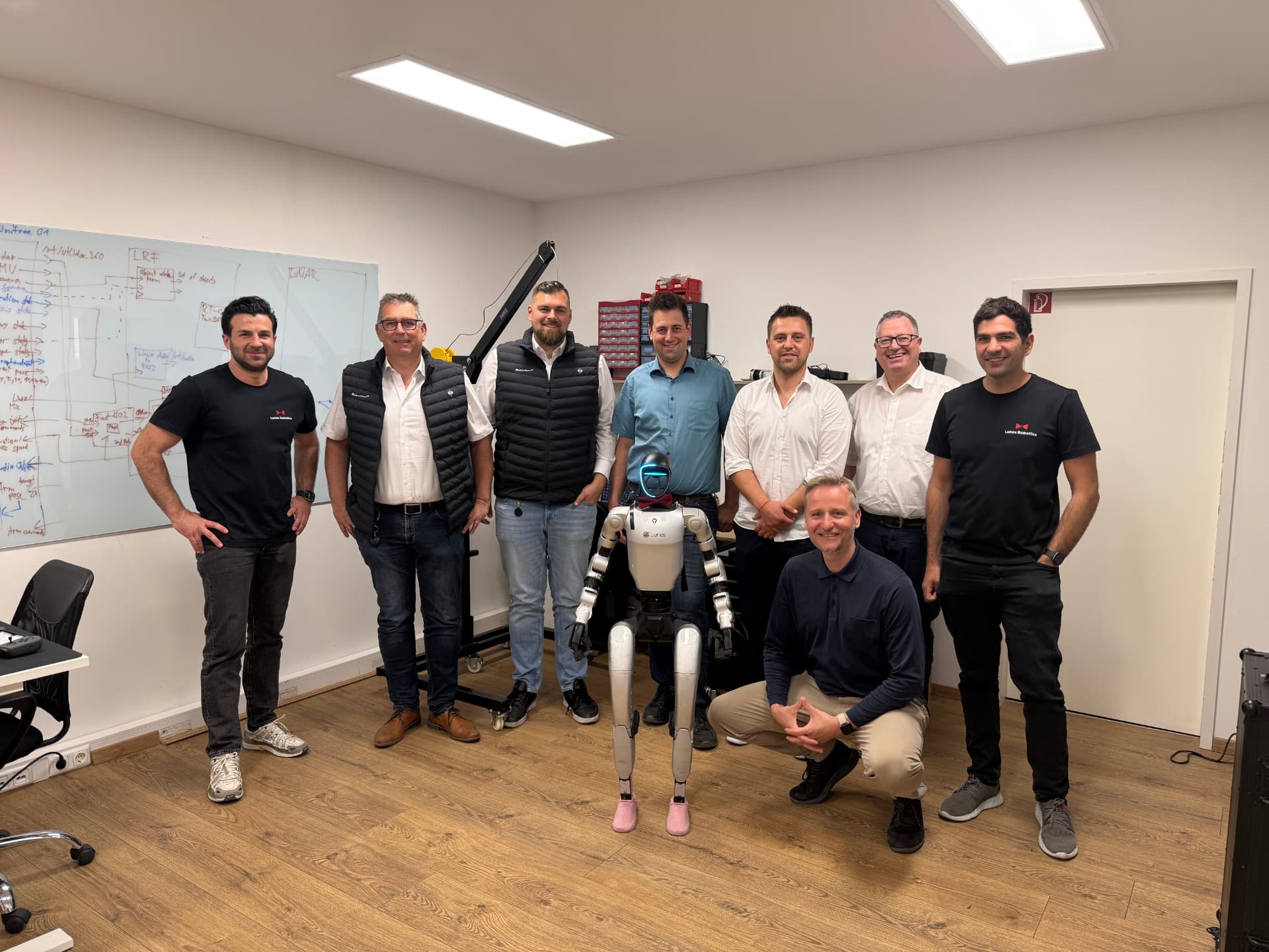 Schweikert team and Lunes Robotics with the humanoid robot in the workshop