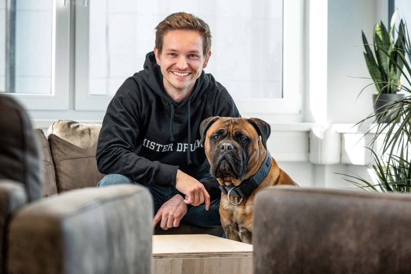 Rune Slembrouck, CEO of Mr. Druck, with his dog in the office
